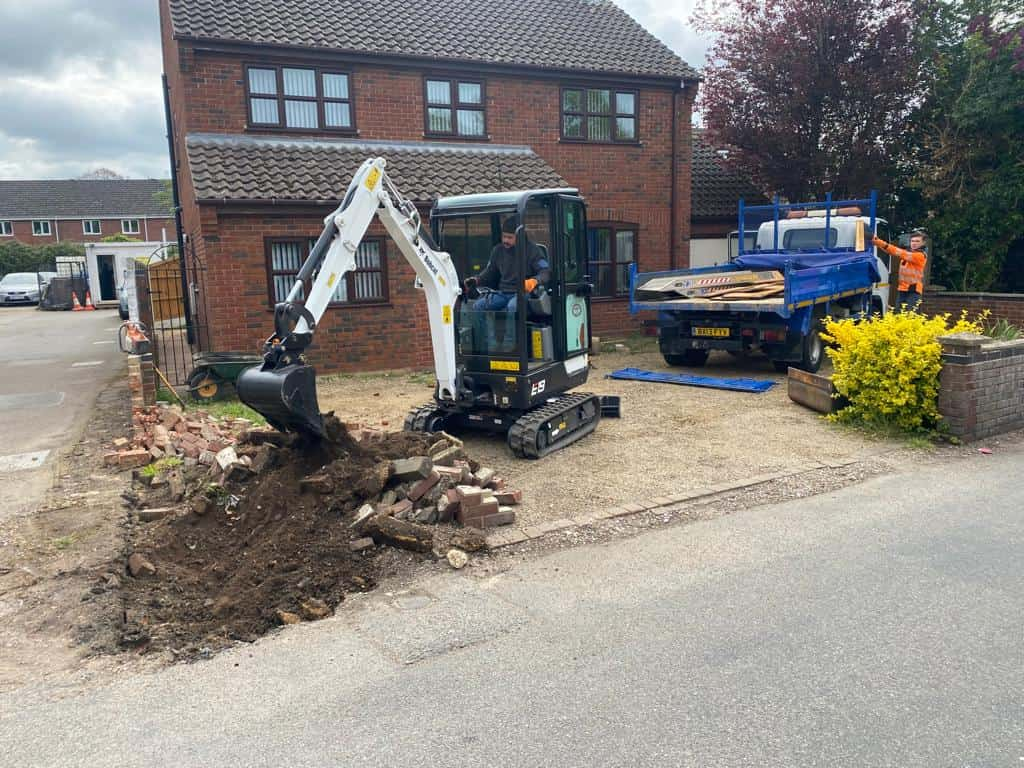 This is a photo of an operative of Tenterden Driveways Digging out for a new tarmac driveway